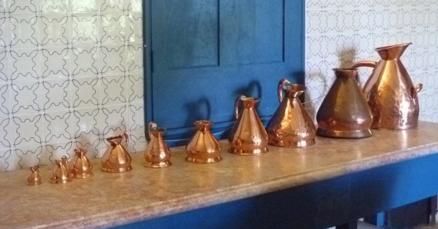Brass jugs in kitchen