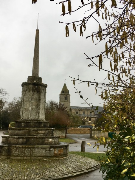 Helpston Cross and church
